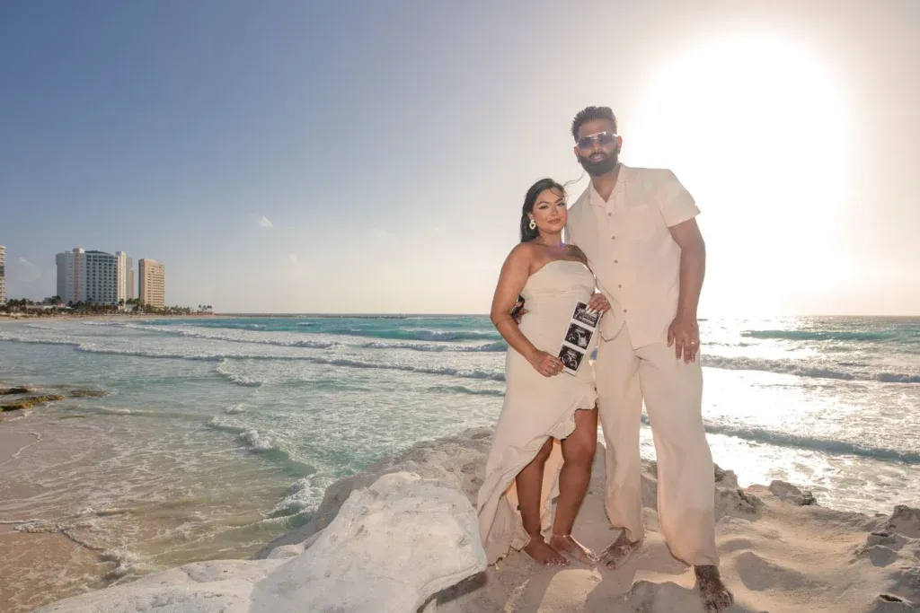 Maternity photographer Cancun capturing a sunrise pregnancy session at Playa Gaviota Azul with golden ocean reflections.