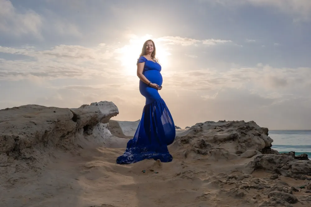 Pregnant woman during a sunrise maternity photography session at Playa Gaviota Azul in Cancun.