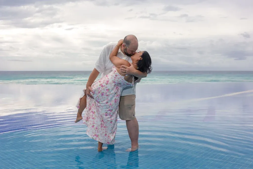 Couple celebrating their engagement on the beach near JW Marriott Cancun after a romantic proposal with an engagement ring.