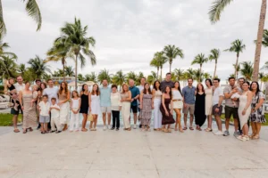 Large family celebrating a grandmother’s 90th birthday at Garza Blanca Resort & Spa Cancun with portraits in the lobby, pool area, and beach.