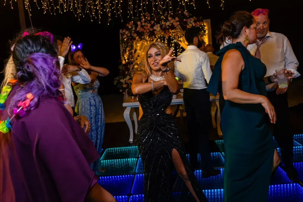 Indian-American wedding celebration at Dreams Natura Cancun featuring a colorful Sangeet event and a beachfront wedding ceremony overlooking the Caribbean Sea.