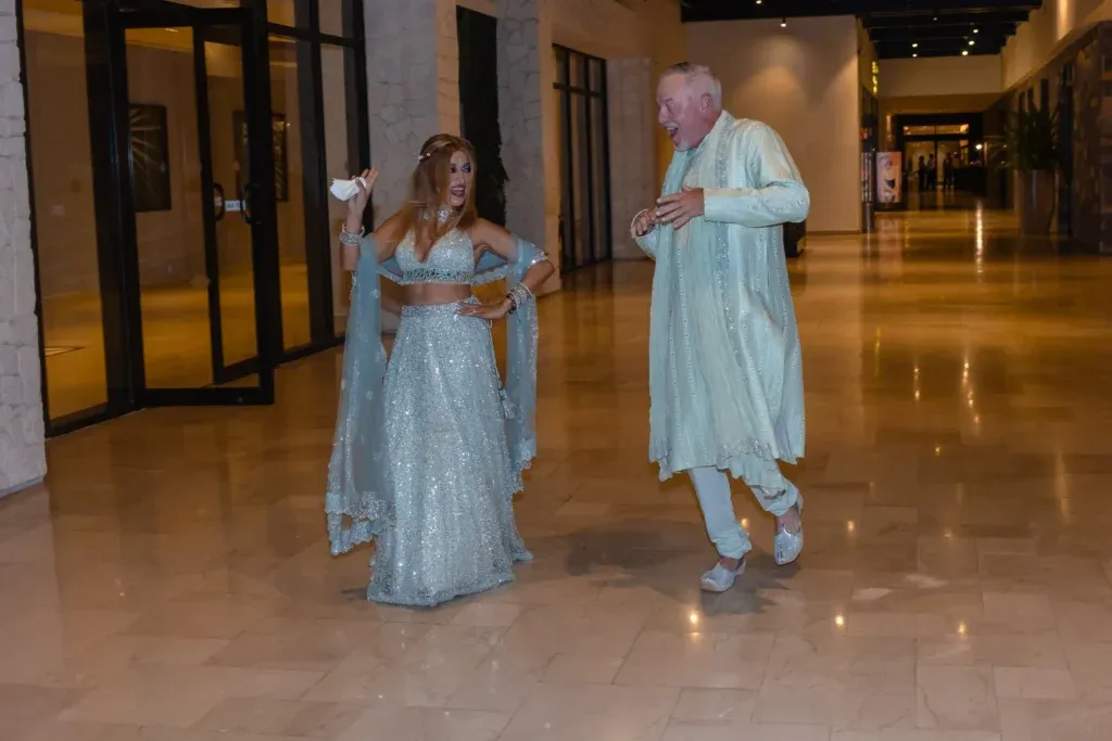Indian-American wedding celebration at Dreams Natura Cancun featuring a colorful Sangeet event and a beachfront wedding ceremony overlooking the Caribbean Sea.