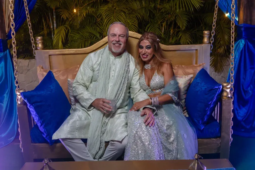 Indian-American wedding celebration at Dreams Natura Cancun featuring a colorful Sangeet event and a beachfront wedding ceremony overlooking the Caribbean Sea.