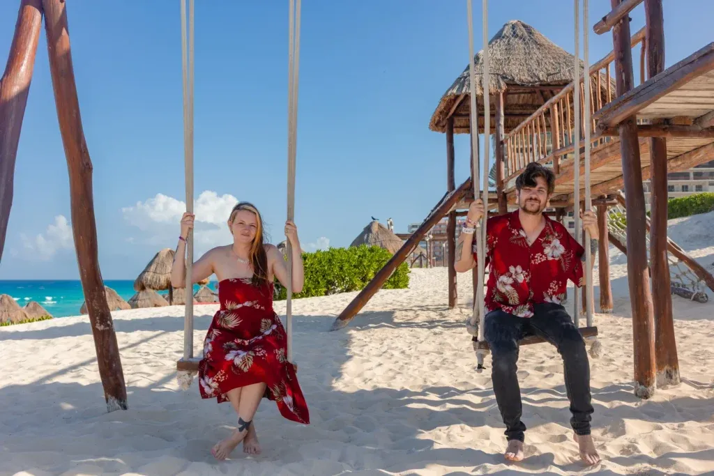 Cancun Couple Photographer capturing a romantic couple session at Playa Delfines with a couple wearing matching outfits during a sunset photoshoot in Cancun.