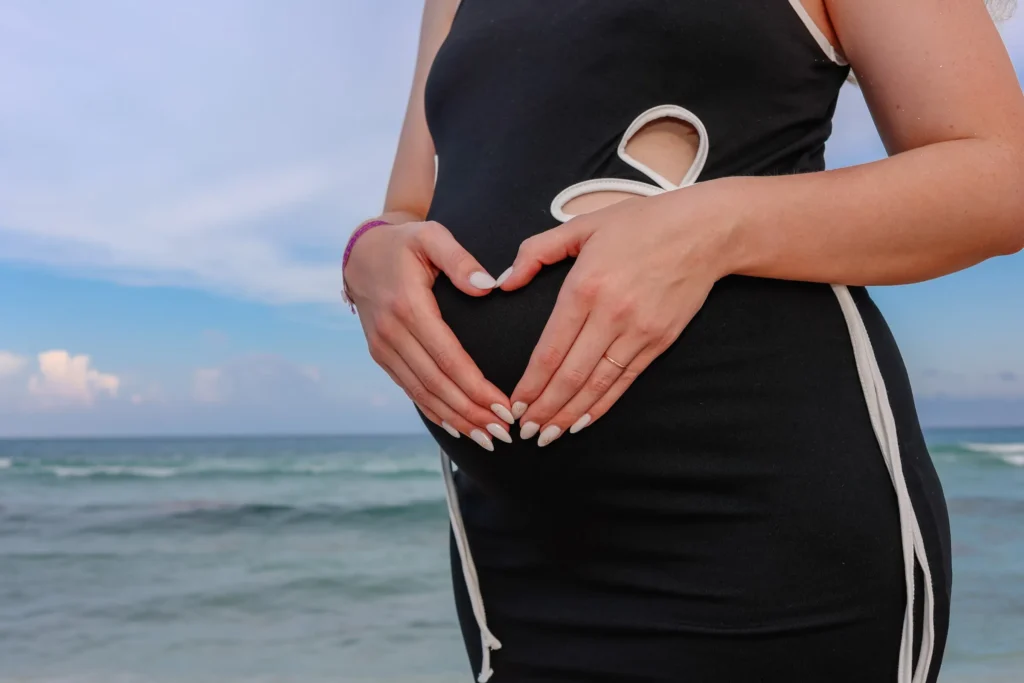 Cancun pregnancy photographer capturing a double maternity session on the beach at Iberostar Selection Cancun during sunset.