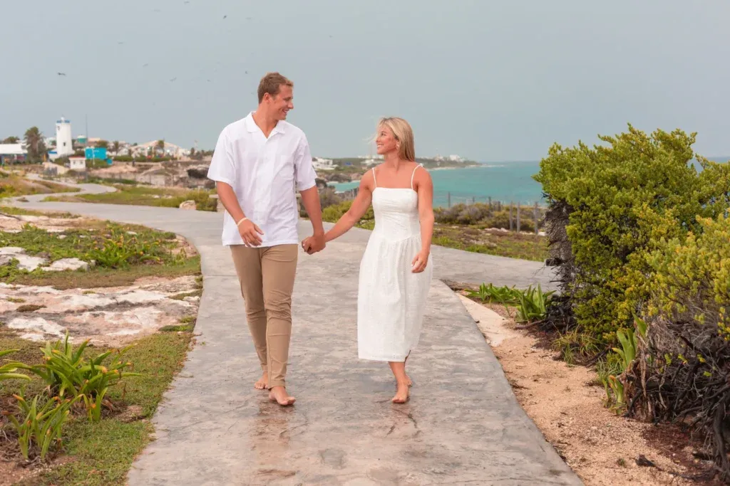 Couple celebrating engagement proposal at Punta Sur cliffs in Isla Mujeres Mexico.