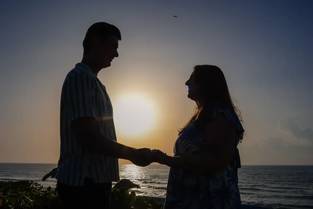 Cancun engagement photographer capturing a romantic sunrise proposal recreation at Playa Delfines.